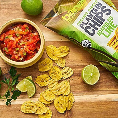 Organic Avocado Lime Chips - Plantain Snack served with salsa, lime wedges, and parsley on a wooden board. Crunchy, zesty chips ideal for healthy snacking.