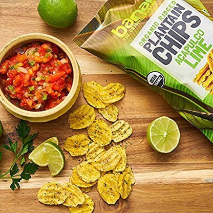 Organic Avocado Lime Chips - Plantain Snack served with salsa, lime wedges, and parsley on a wooden board. Crunchy, zesty chips ideal for healthy snacking.